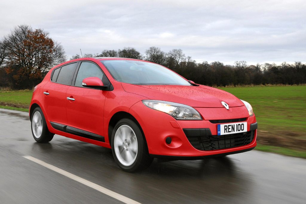 Red Renault Megane on the road in the rain