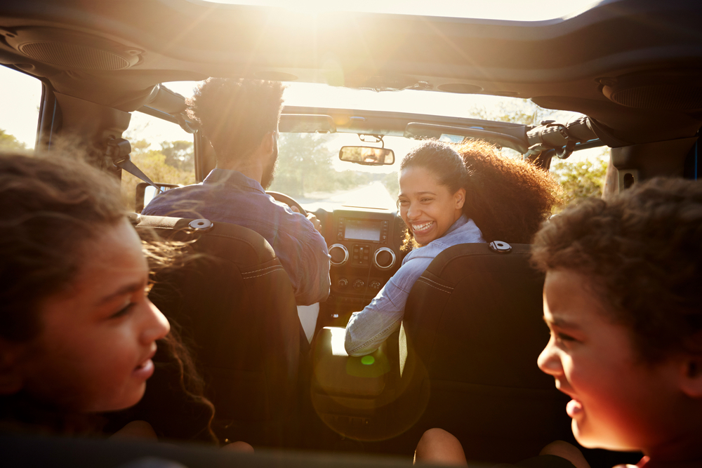 family in a car smiling