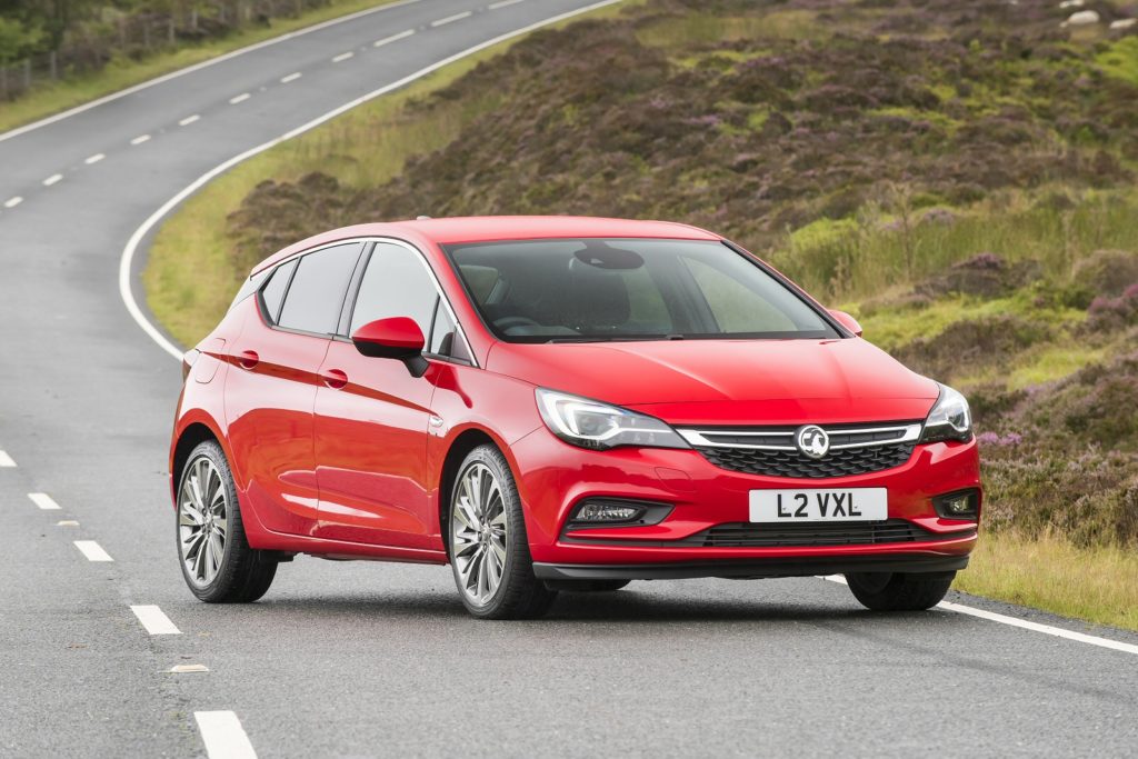 Red Vauxhall Astra driving on the road