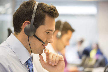 man with a headset talking to a customer