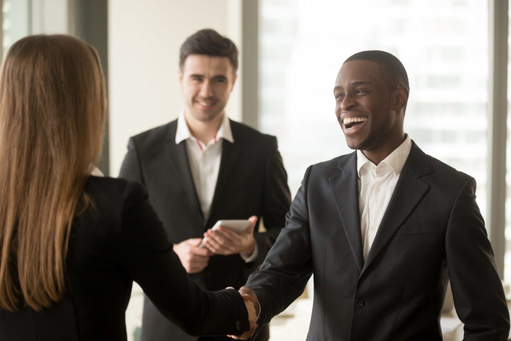 Employees shaking hands celebrating rewards