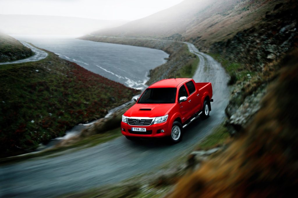 Red Toyota Hilux on the road