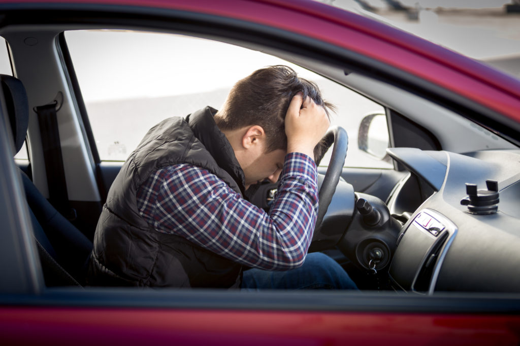 Man in red car unhappy