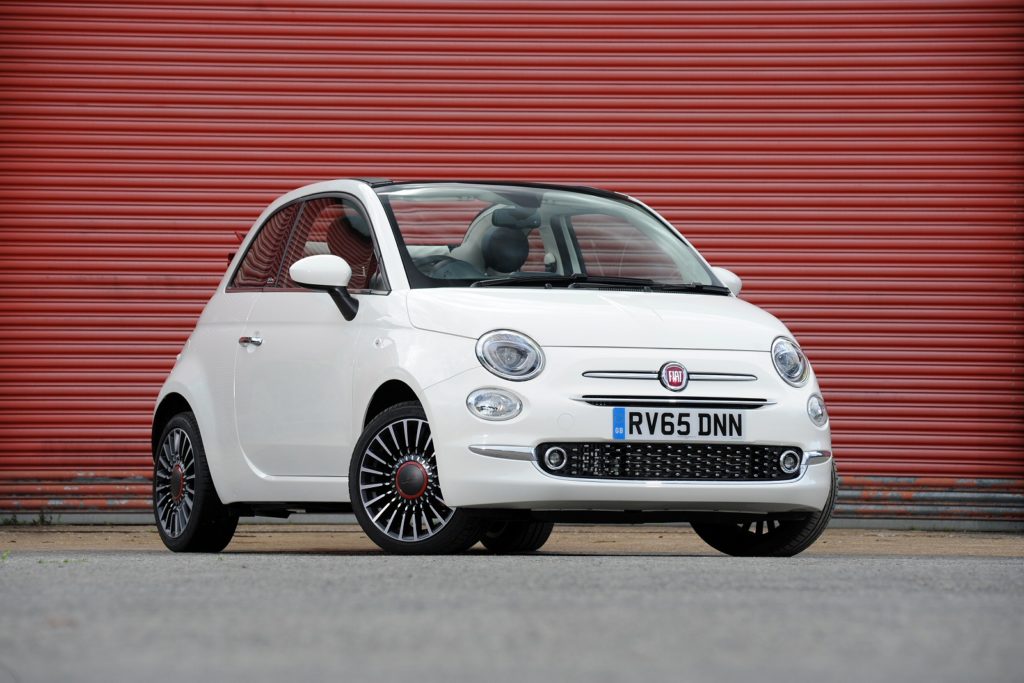 Fiat 500 C Convertible in white parked with red garage door behind