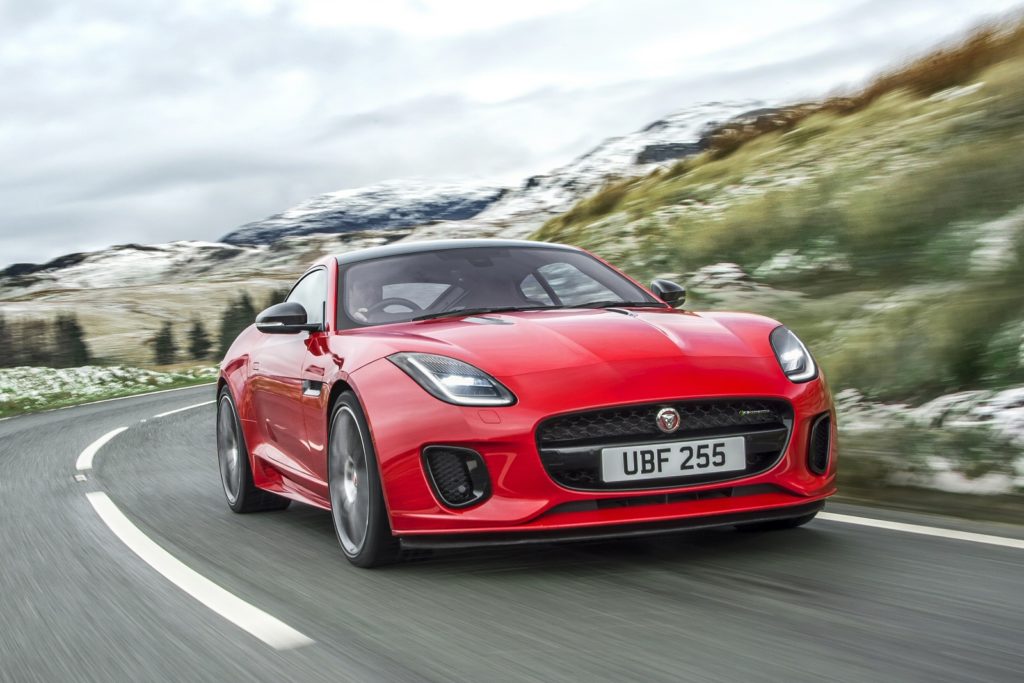 red Jaguar f-type coupe driving round a corner