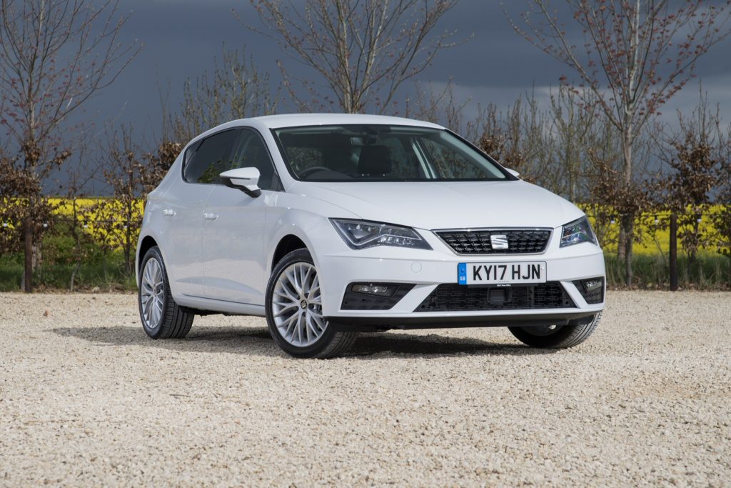 White SEAT Leon off track with fields in the background