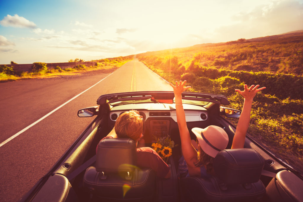 Couple driving in convertible