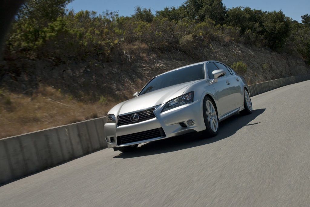 Silver lexus gs saloon driving on tarmac road