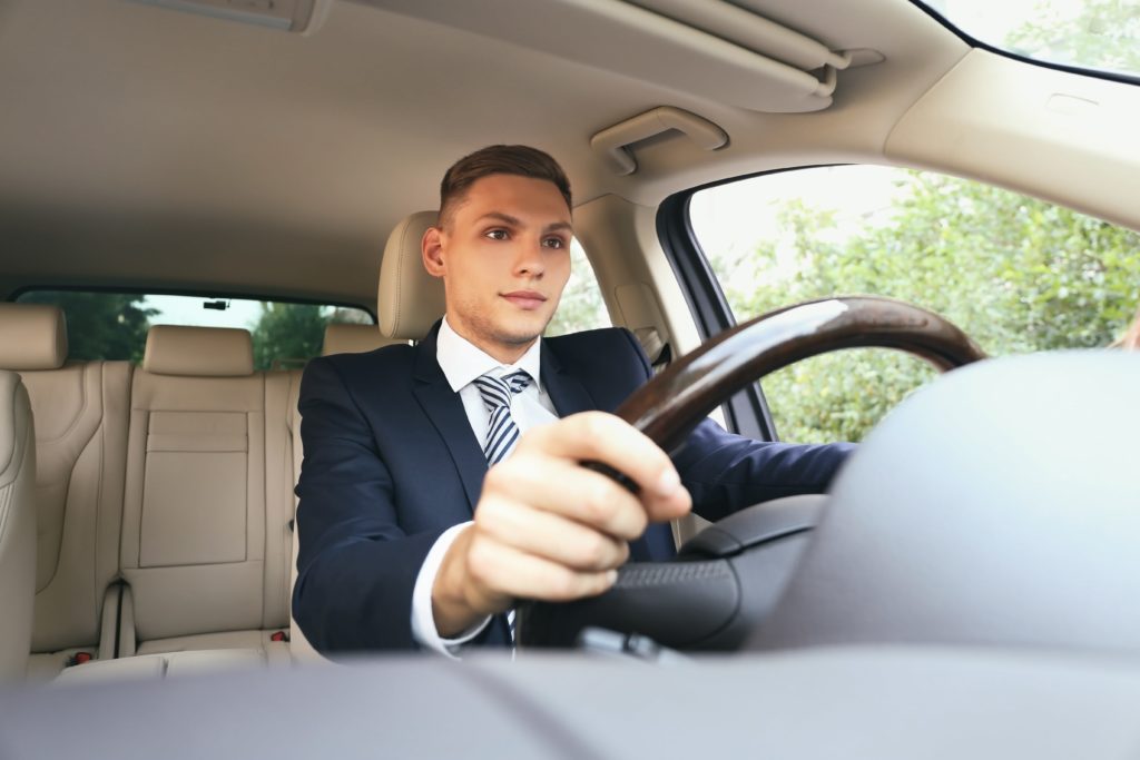 business guy driving nice car