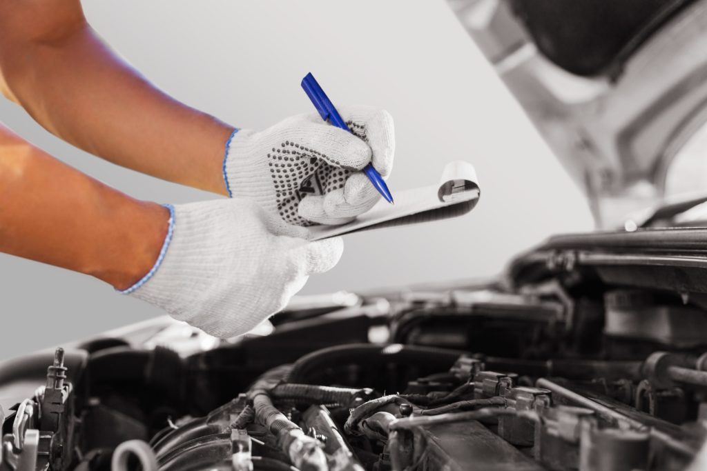 car mechanic checking the engine