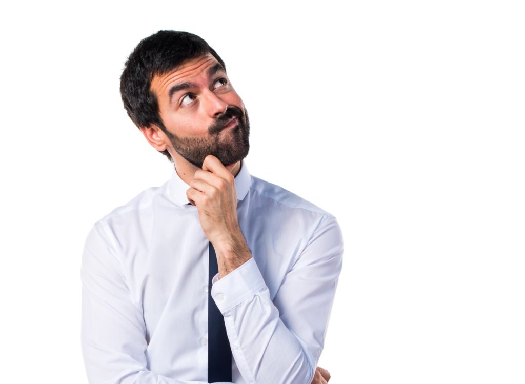 Man wearing white shirt thinking.