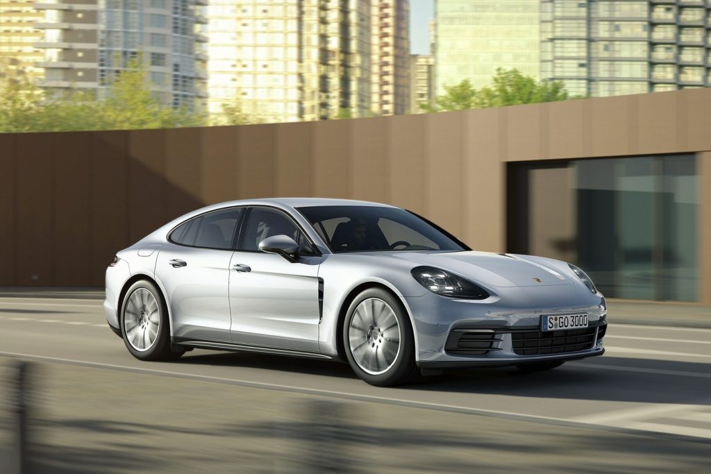 Silver Porsche Panamera driving town city road