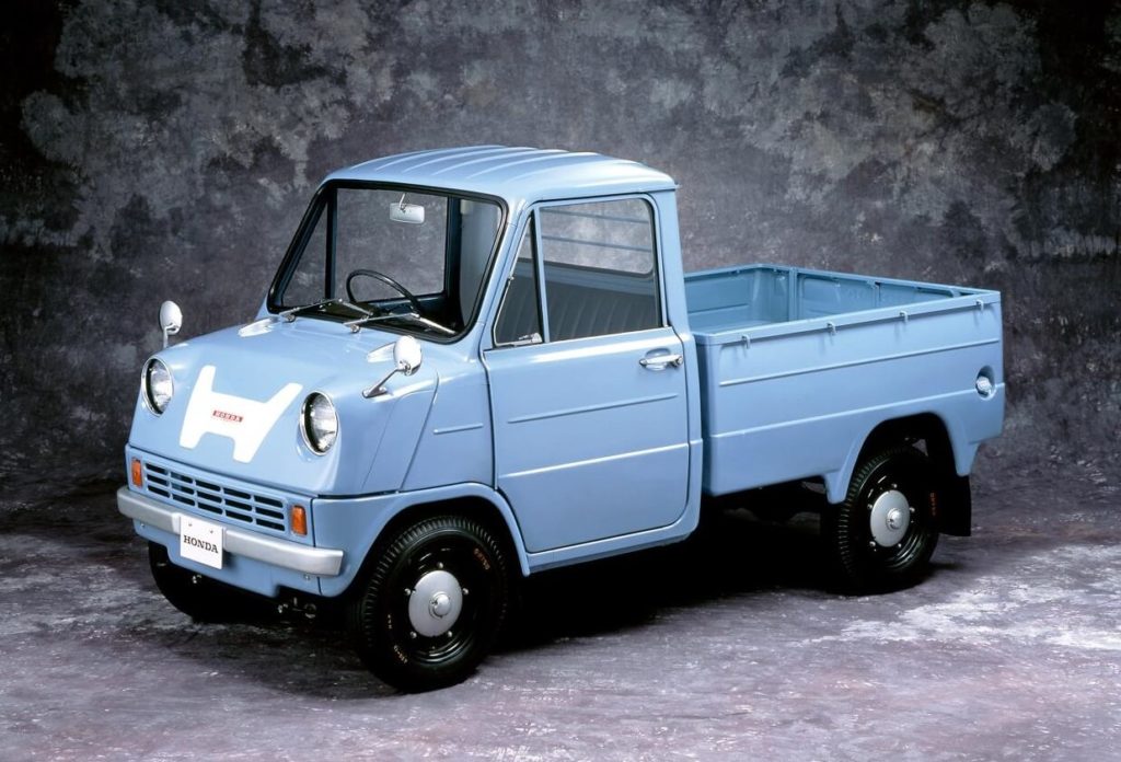 Honda T360 parked on a grey background