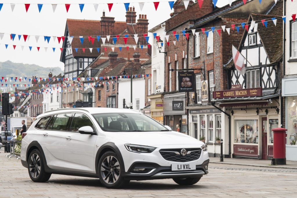 a metallic white Vauxhall Insignia Country Tourer parked on brick road in town centre